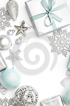 Silver and pastel blue christmas gifts, ornaments and decorations isolated on white background. Christmas border.