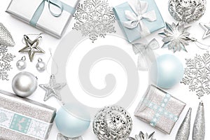 Silver and pastel blue christmas gifts, ornaments and decorations isolated on white background. Christmas border.