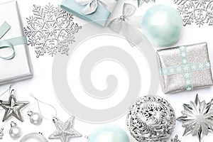 Silver and pastel blue christmas gifts, ornaments and decorations isolated on white background.