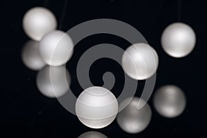 Silver pearl balls on a black background