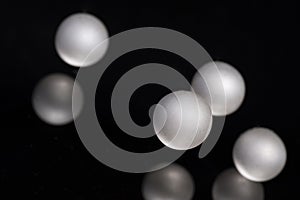 Silver pearl balls on a black background