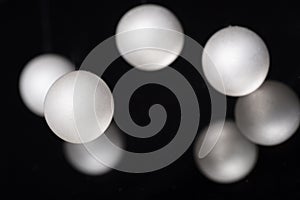 Silver pearl balls on a black background