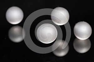 Silver pearl balls on a black background