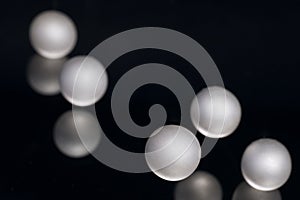 Silver pearl balls on a black background