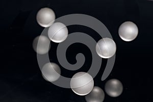 Silver pearl balls on a black background