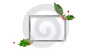 Silver photo or  poster  frame and  winter red holly berry with leaves isolated on white background