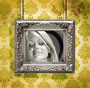 Silver picture frame against floral wallpaper