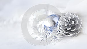 Silver pine cones on white winter concept with copyspace on background