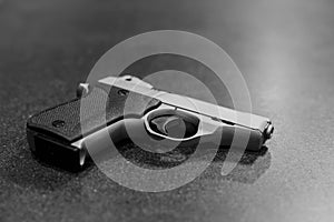 Silver Pistol Isolated on Dark Table Black & White