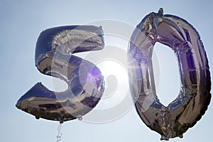 Silver plastic balloons for a 50th