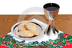 Silver plate with bread and Chalice on Christmas background