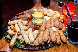 Silver plate full of appetizers finger food starters at party.