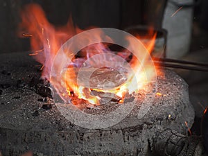 Silver plate glowing on an old fashioned appropriate fireplace