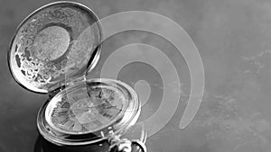 Silver pocket watch close up on marble background