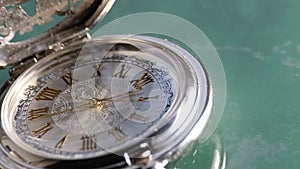 Silver pocket watch close up on marble background