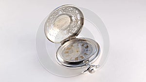 Silver pocket watch close up on white background