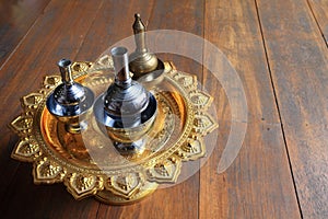 Silver pour water containers on golden tray