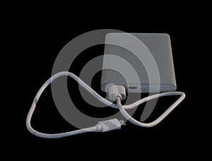 A silver powerbank with white micro usb cable
