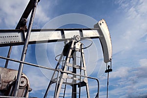 Silver pumpjack in crude oil field mine