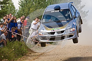 Silver race car Mitsubishi Lancer at rally