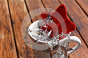 Silver and red Christmas, cup and stars on wooden background