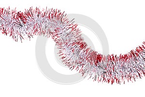 Silver and red Christmas tinsel, white background.