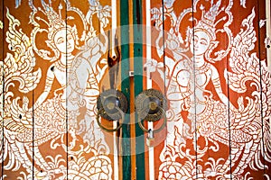 Silver and red thai art culture door in the temple