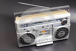 Silver retro ghetto radio boom box cassette recorder from 80s on black background