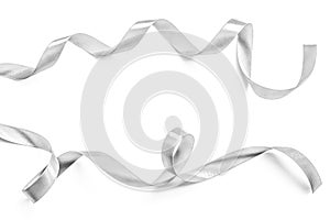 Silver ribbon bow in bright silver white grey color isolated on white background with clipping path for holiday and party greeting