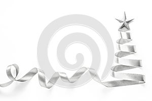 Silver ribbon Christmas tree made of satin bow scroll with star isolated on white background with clipping path for winter xmas