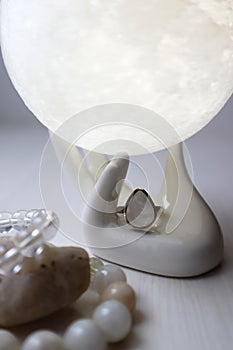 Silver ring with moonstone in ceramic hand with moon.