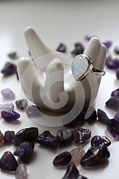 Silver ring with moonstone on porcelain hand and amethyst kiesel.