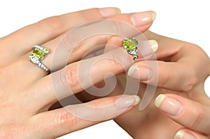 Silver ring with peridot on finger