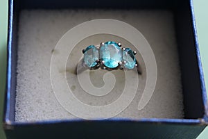 Silver ring with three blue gems