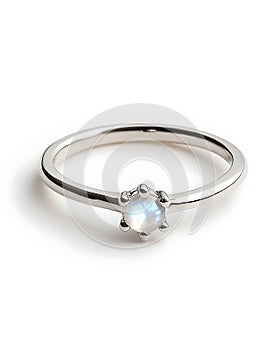 A silver ring with a white stone in the center