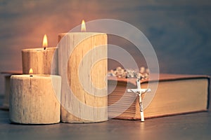 Silver rosary candles and crucifix