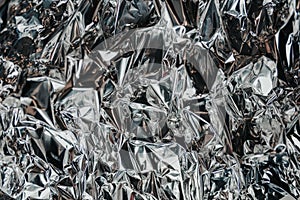 Silver rumpled foil. Gray background with texture