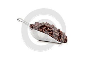 A silver scoop with coffee beans on white