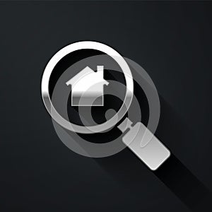 Silver Search house icon isolated on black background. Real estate symbol of a house under magnifying glass. Long shadow