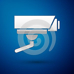 Silver Security camera icon isolated on blue background. Vector