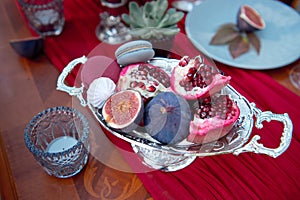 Silver serving dish with pomegranate and figs