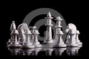 Silver set chess pieces on a black
