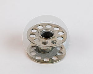 Silver sewing machine bobbin white