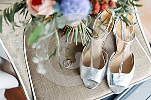 Silver shoes, wedding rings and a bouquet
