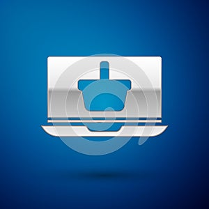 Silver Shopping basket on screen laptop icon isolated on blue background. Concept e-commerce, e-business, online