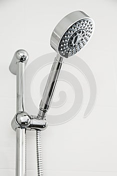 Silver shower head in bathroom with water drops flowing in blue and cool picture style, Bathroom equipment