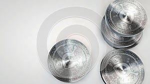 Silver siacoin coins falling on white background