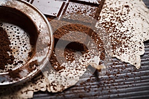 Silver sieve with cocoa dust on chocolate