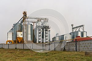 silver silos on agro manufacturing plant for processing drying cleaning and storage of agricultural products, flour, cereals and