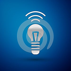 Silver Smart light bulb system icon isolated on blue background. Energy and idea symbol. Internet of things concept with